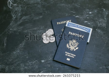 Two American passports on black background. American citizenship. Social security card in a document. Traveling around the world. Coins on a side