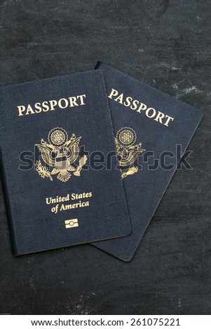 Two US passports on black background. American citizenship. Traveling around the world.