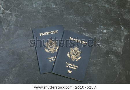 Two US passports on black background. American citizenship. Traveling around the world.
