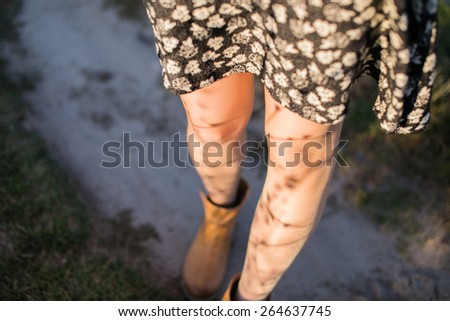 Image of legs of a young woman at sunset