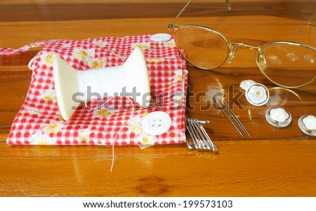 Sewing needles Including , thread, buttons, brooches and wear glasses to see clearly.
