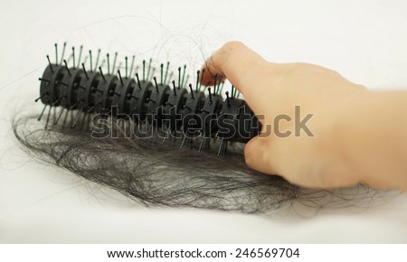 Women with hair loss problems, there are many hair attached to a comb after use.