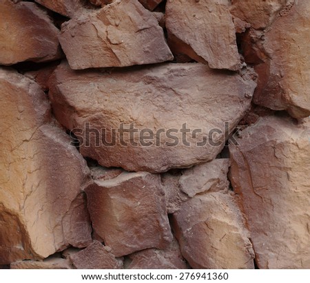 Background of stone wall texture, brown color in day time.