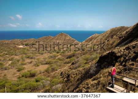Woman looking out at diamond head crater, Oahu Hawaii.