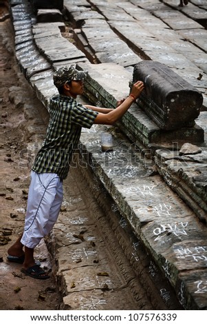 SIEM REAP, CAMBODIA - DECEMBER 26: Unidentified worker marks stones  during restoration efforts at most visited UNESCO World Heritage Site, Angkor Wat, December 26, 2008 in Siem Reap, Cambodia.