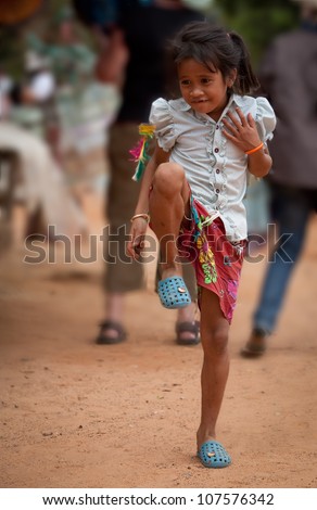 SIEM REAP, CAMBODIA - DECEMBER 28: Unidentified girl plays with a kick toy at market in Angkor Wat, UNESCO World Heritage site most visited on December 28, 2008 in Siem Reap, Cambodia.