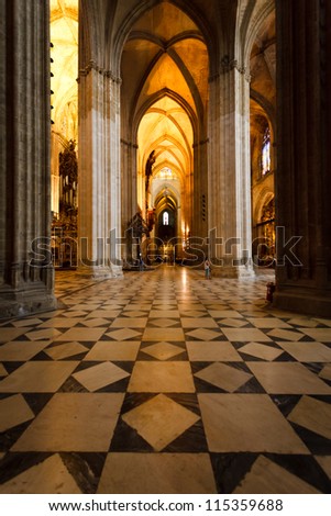SEVILLE, SPAIN - MAY 1,2010: illuminated cathedral highlighting magnificent gothic arches marble floor on May 1, 2010 in Seville Spain A New UNESCO World Heritage Site report commits to preservation