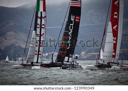 SAN FRANCISCO - AUGUST 25: Two Team Prada boats and Team Oracle Boat neck and neck in Louis Vuitton Race Cup race on August 25, 2012 in San Francisco,  where cup finals will be held summer 2013.