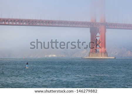 SAN FRANCISCO, CALIFORNIA - SEPTEMBER 2: Stand up Paddle Boarder and Golden Gate Bridge as morning fog lifts on September 2, 2011 in San Francisco, California.host of the 2013 Americas Cup sail races.