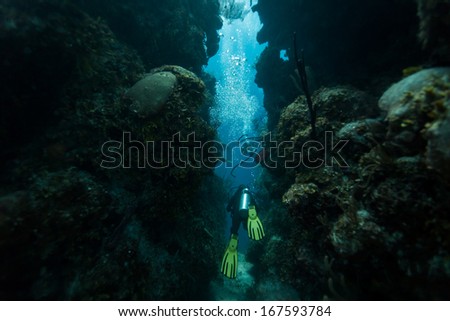 Blue Hole, Belize - November 26: Scuba Diver Swims Through Tunnel On November 26, 2013 In Blue Hole, Caribbean Sea, Belize