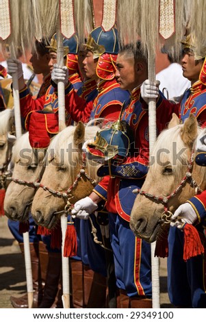 ULAN BATOR, MONGOLIA - JULY 11: Traditional Mongolian cavalry color guard begins Nadaam National Games by delivering nine ceremonial white yak tails to the stadium. July 11, 2008 Ulan Bator, Mongolia