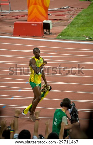 BEIJING - AUG 16: Sprinter Usain Bolt\'s victory lap after setting world record for men\'s 100 Meter sprint at the Olympics. Bolt later gains the title World\'s Fastest Man August 16, 2008 Beijing, China