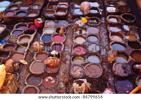 FEZ, MOROCCO - DEC 22: Unidentified workers processing hides in colorful tanning pools at a traditional leather tannery,  December 22, 2009 Fez, Morocco.