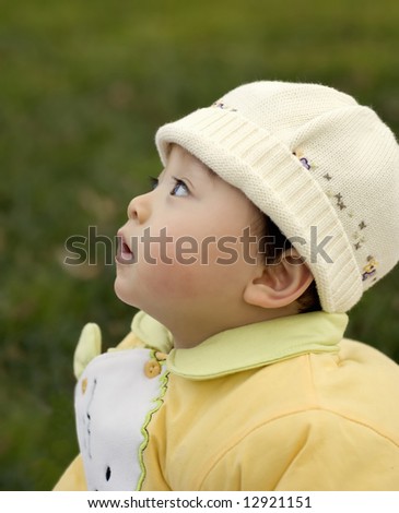 Side portrait of a baby in hat.