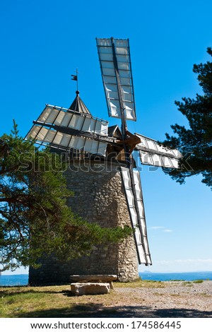 Wind mill on a hill top under clear sky in Provence
