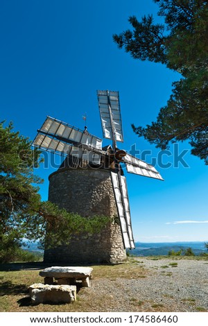 Wind mill on a hill top under clear sky in Provence