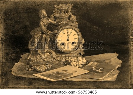 Antique clocks, jewelry and photographs on a dark background, stylized antique photos