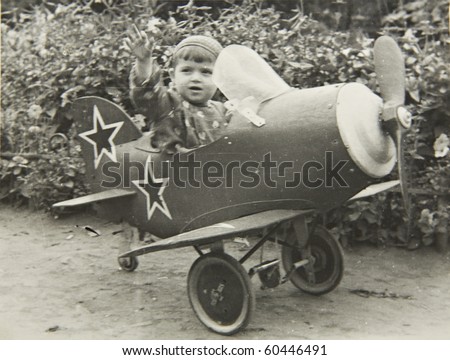 A little boy on the plane, an old picture of 40 years of XX century.