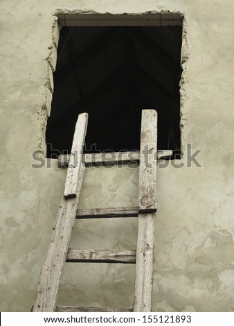 Old wooden vintage curve ladder near a wall concept