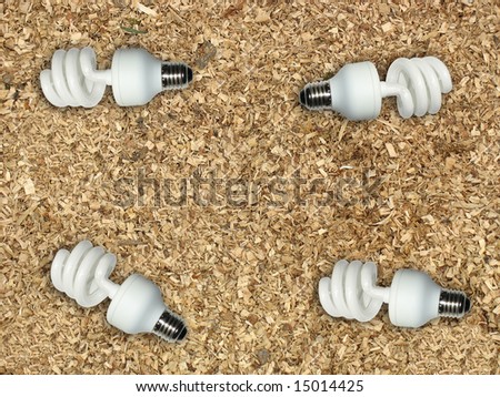 Ecological concept energy saving light bulb on wooden chips background
