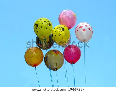 Bunch of colored party balloons against blue sky