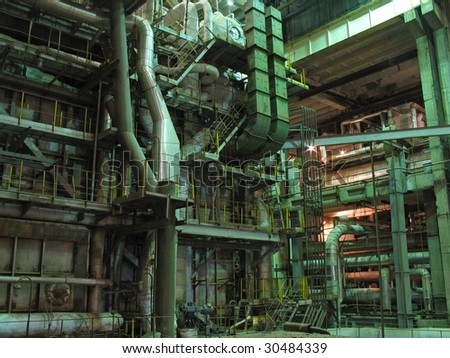 machinery, pipes, tubes, steam turbine at a power plant, night scene