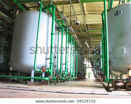 Line of industrial chemical tanks at a power plant
