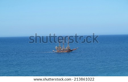 Vintage wooden pirate old ship in blue sea