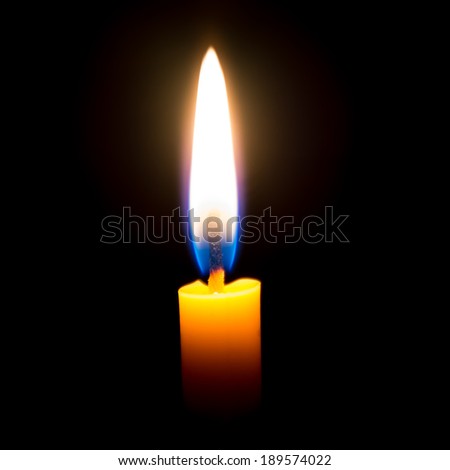 Burning praying candle isolated on black background