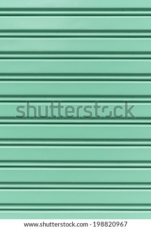 Corrugated green metal sheet wall texture background.