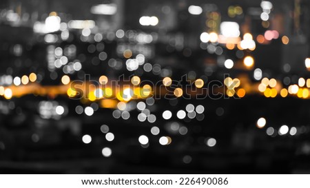 Dark orange and black city light blur bokeh, defocused background.