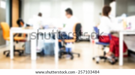 People in office organization blur background with bokeh.