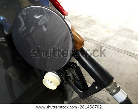 Oil fill in car in petrol gas station.