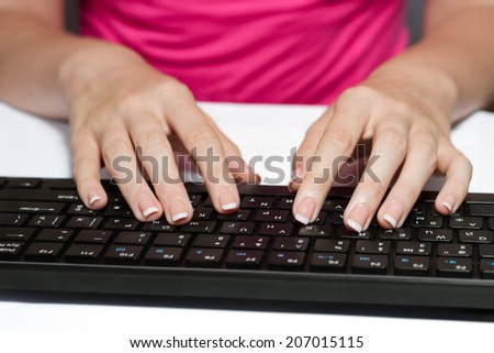 Woman With French Manicure Typing On A Black Keyboard