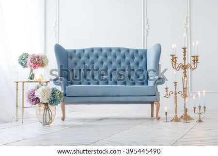 Beautiful Provance Living Room With Blue Sofa Near Table With Flowers And Candles