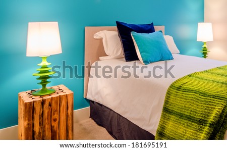 Modern blue bedroom interior in a luxury house with reclaimed wood bedside tables
