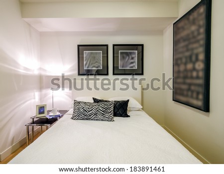 Modern bedroom interior design with black pattern designer pillow accents in a luxury house