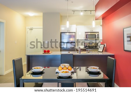 Modern red dining room with kitchen in a luxury apartment. Interior design.