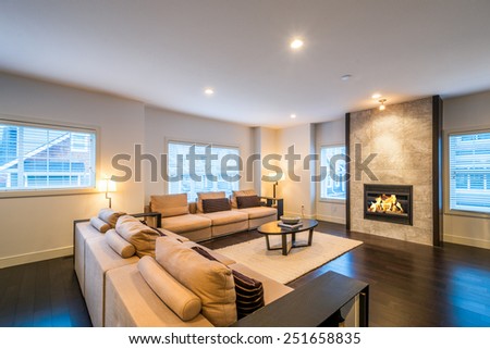 Spacious bright living room with fireplace in luxury house. Interior design.