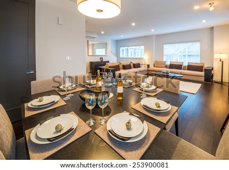Table set for dinner in a spacious modern dining room. Interior design.