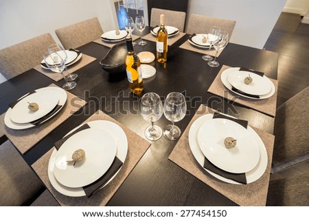 Bright dining room table set for dinner. Interior design.