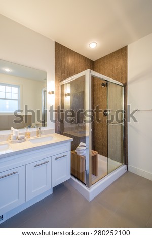 Luxury bright bathroom with a shower cabin. Interior design.
