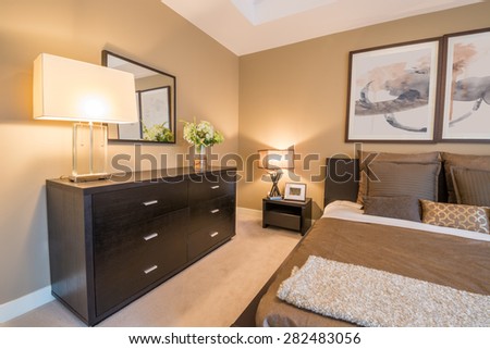 Modern bright bedroom interior with a large dresser and mirror.