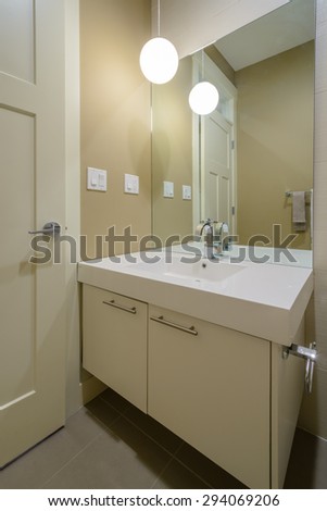 Modern bright bathroom with sink and large mirror. Interior design.