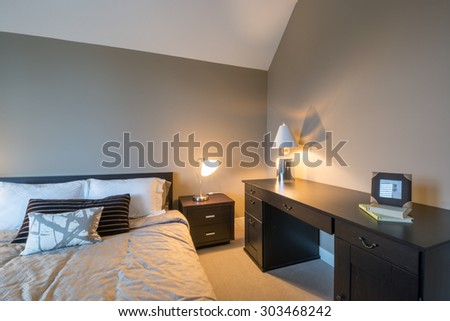 Modern bright bedroom interior design with night tables and office desk.