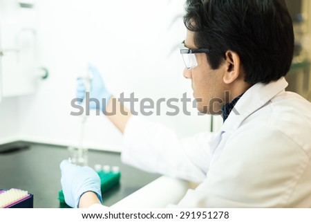 Researcher working with a Pipette in a Biochemistry Lab