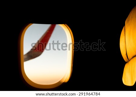 Illuminated black Seat with orange Light in a flight