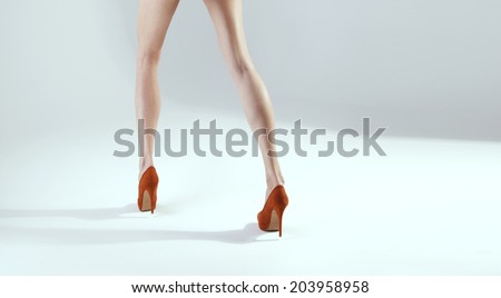 Long slim sexy legs. Conceptual photo of high heels on woman legs