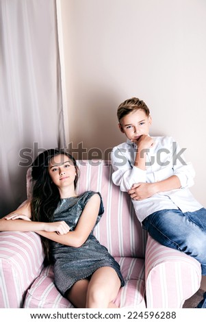 Young fashionable teenagers posing in elegant clothes.