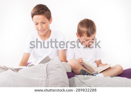 Two brothers reading books. Family portrait.